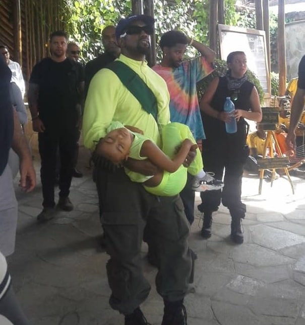 Kanye West wiith his daughter North West who was all tired from the days activities
