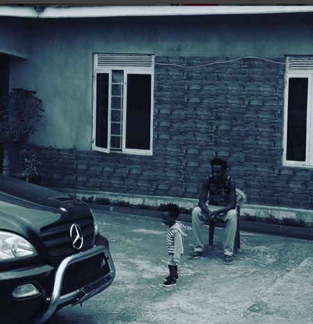 Mun G and his son at his recently completed house