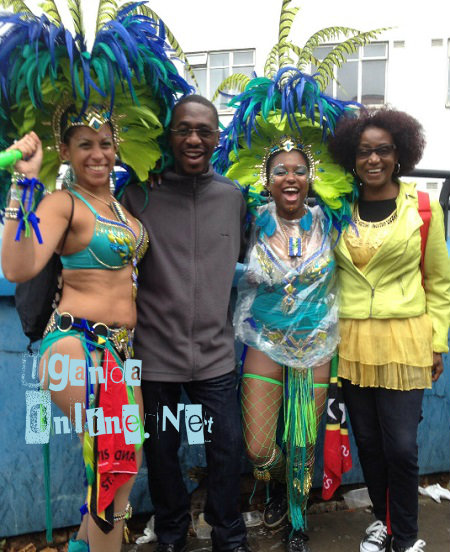 Noting Hill Carnival models posing with some of the Ugandans that attended