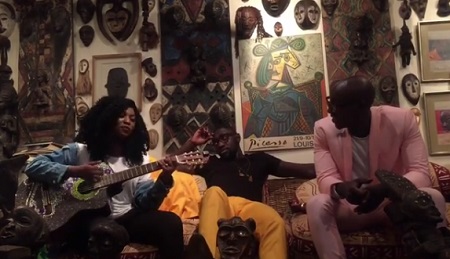 Irene plays with her guitar as the Sauti Sol guys look on