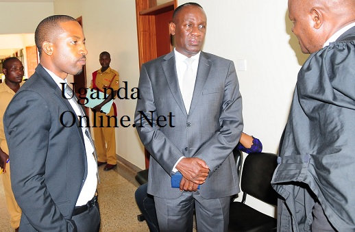 Meddie and Capt Mike Mukula listen to a lawyer at the commercial court