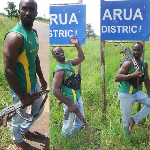 Farouk Sempala strikes a pose with his AK47 IN Arua District